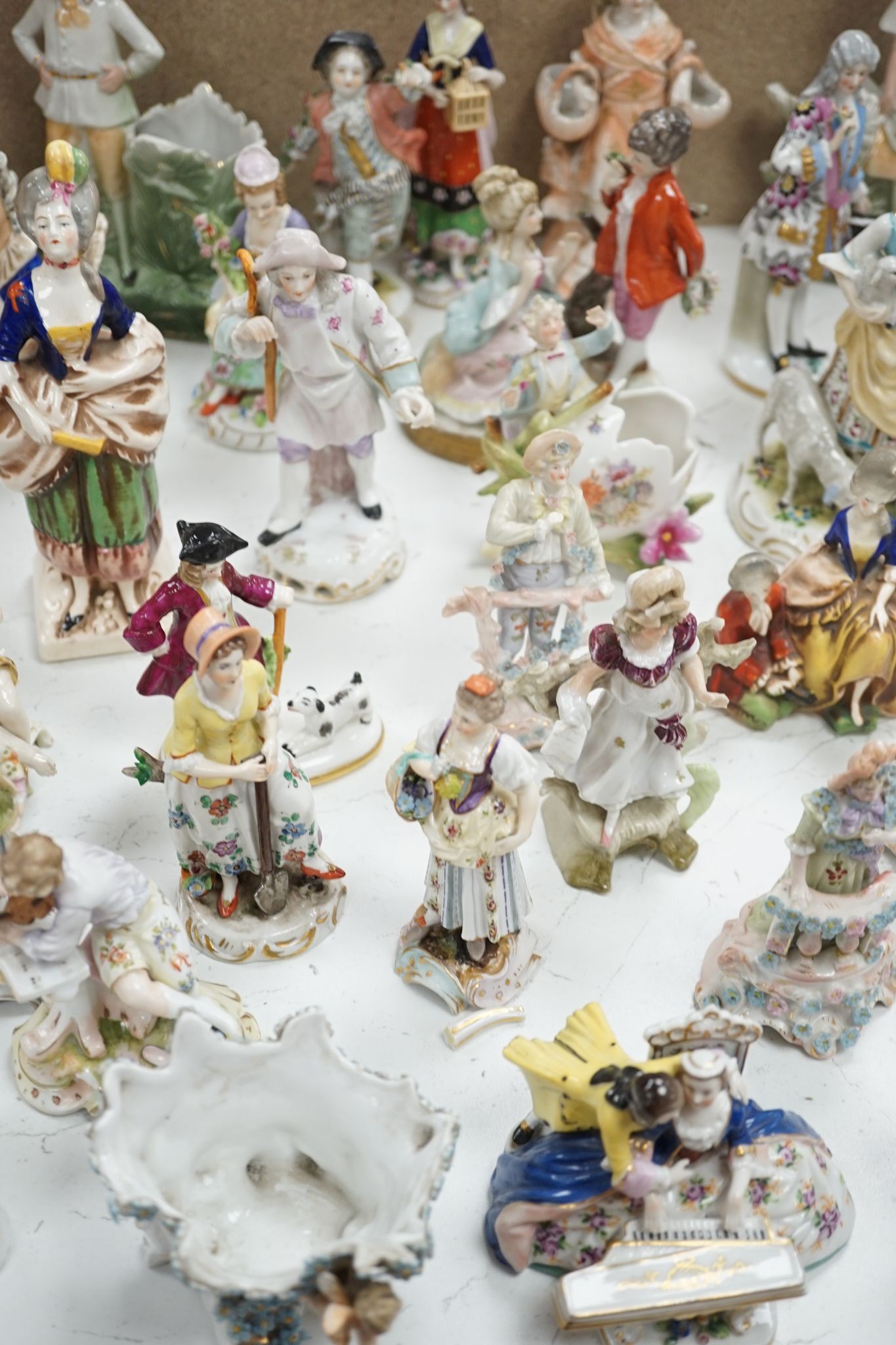 A large collection of small to medium German, French and English porcelain figurines and groups, tallest 18cm